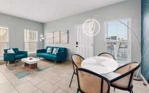 a living room with a table and chairs at SPI Beach Condo - Just a block away to Paradise in South Padre Island