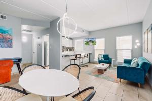 a living room with a table and chairs at SPI Beach Condo - Just a block away to Paradise in South Padre Island
