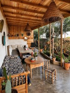 an outdoor patio with a couch and a table at Sun & Sea Lodge Ocean roof in Essaouira