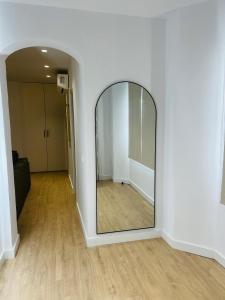 a large mirror in a room with a hallway at Palacios Centro - El Puerto in El Puerto de Santa María