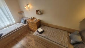 a small bedroom with a bed and a dresser at Kicsi Rigó Vendégház in Bogács