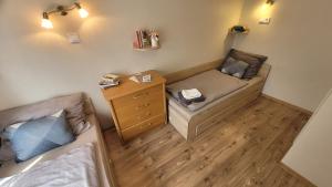 a small room with a bed and a night stand at Kicsi Rigó Vendégház in Bogács