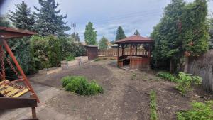 a garden with a gazebo in a yard at Kicsi Rigó Vendégház in Bogács