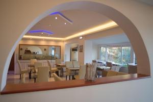a living room with an archway and a dining room at Oasis Boutique Hotel in Nydri