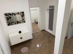 a room with a mirror and a white dresser at Komfortresidenz Harmonie in Weiz