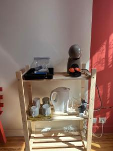 a wooden shelf with cups and a coffee maker on it at Les Suites du Quai in Montmélian +17 photos