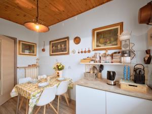 a kitchen and dining room with a table and chairs at Casa Heli 1 lake view in San Zeno di Montagna