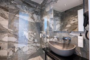a bathroom with a sink and a mirror at Vila Era Beach 2 in Sarandë +101 photos