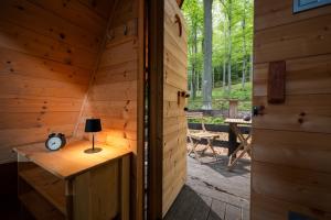 an inside view of a wooden cabin with a table and a lamp at Nature's Nest - The Woods in Maribor