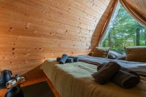 a bedroom with two beds in a log cabin at Nature's Nest - The Woods in Maribor