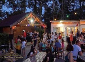 a crowd of people standing in front of two sheds at Les mobil homes d’oliver rob in Saint-Chéron +40 photos