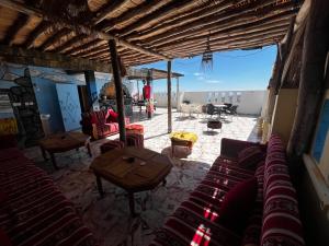 a living room with red couches and a table at Azour House in Taghazout
