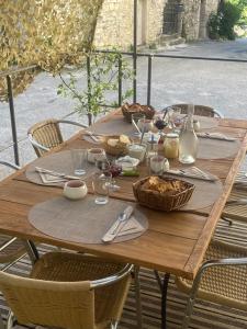 a wooden table with food on top of it at Hôtel CASITA in Puygiron +60 photos