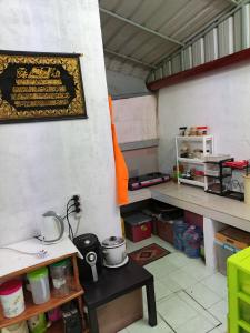 a room with a counter and a table in it at Homestay Rumah Inap ABC Semi-D in Pasir Mas
