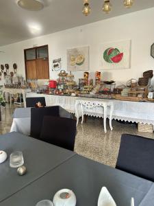 a dining room with a table with chairs and a buffet at Hotel Rocamar in Cala Figuera
