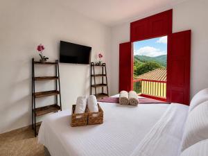 a bedroom with a bed and a window with a view at El Portón de Salento in Salento
