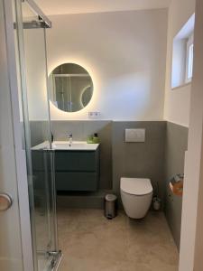 a bathroom with a sink and a toilet and a mirror at Zimmer Room Trogir Kastela Split in Kaštela