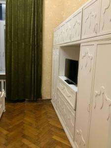 a room with a white cabinet with a tv in it at Український Театр 2-х кімнатні Апартаменти in Odesa