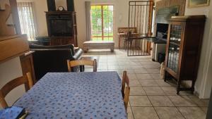 a dining room with a table and a living room at Kings Place Montagu in Montagu +11 photos