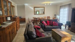 a living room with two leather couches and a table at Kings Place Montagu in Montagu