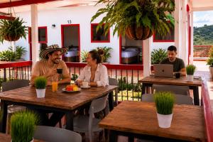 a group of people sitting at tables in a restaurant at El Portón de Salento in Salento