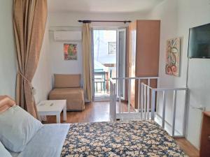 a bedroom with a bed and a living room with a balcony at Villa Rena in Batsi +74 photos