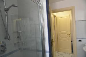 a bathroom with a shower and a glass shower door at appartamento Macchia in Agropoli +8 photos