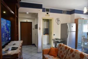 a living room with a table and a refrigerator at appartamento Macchia in Agropoli