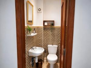 a bathroom with a toilet and a sink at Beachside Garden Apartment in Marina Smir in Marina Smir