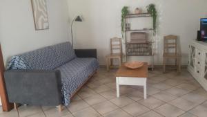a living room with a couch and a table at Au Chablis Serein in Chablis
