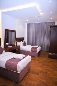 a hotel room with two beds and a desk at روعة نجد المغرزات in Riyadh +138 photos