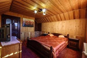 a bedroom with a bed in a wooden room at Korona Karpat in Lazeshchyna +62 photos