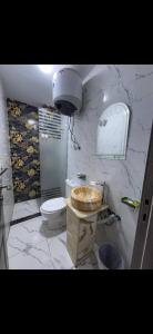 a bathroom with a toilet and a sink at Osiris Cairo Hotel Downtown in Cairo