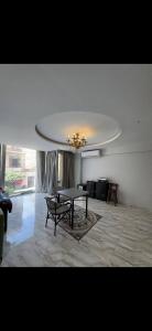 a living room with a table and a ceiling at Osiris Cairo Hotel Downtown in Cairo