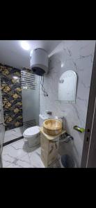 a white bathroom with a toilet and a sink at Osiris Cairo Hotel Downtown in Cairo +5 photos