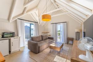 a living room with a couch and a table at Eden on Walton 1 in Sea Vista
