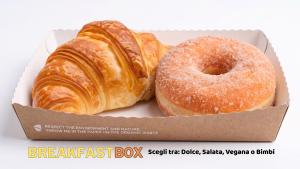 two donuts sitting in a box at Hurz in Pietrelcina