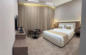 a hotel room with a large bed and a table at فندق شفت جازان Shift Jizan Hotel in Jazan