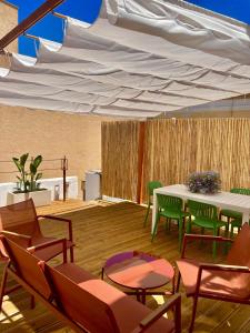 a patio with a table and chairs under a white tent at Amare Gallipoli in Gallipoli