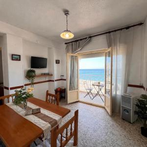 a dining room with a table and a view of the ocean at Todimer Acera del Mar in Torrenueva