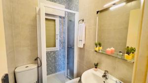 a bathroom with a shower and a toilet and a sink at Todimer Acera del Mar in Torrenueva +17 photos