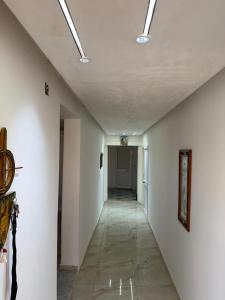 an empty hallway with white walls and a ceiling at Radi in Menzel Jemil +3 photos