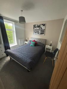 a bedroom with a bed with two pillows on it at Nirvana house in Deepcar