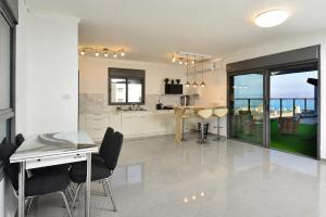 a kitchen and dining room with a view of the ocean at Kinneret Royal Penthouse in Tiberias