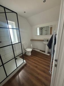 a bathroom with a toilet and a sink at Nirvana house in Deepcar
