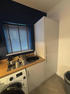 a small kitchen with a sink and a window at Nirvana house in Deepcar +9 photos