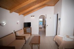 a living room with a couch and a table at Oasis Boutique Hotel in Nydri