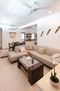 a living room with a couch and a table at Private Pool, Beach Access 3BR Sleeps 6 in Chelem