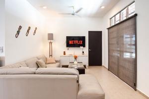 a living room with a couch and a sliding door at Private Pool, Beach Access 3BR Sleeps 6 in Chelem