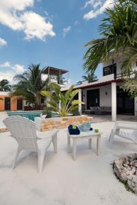 a patio with two chairs and a table and a pool at Private Pool, Beach Access 3BR Sleeps 6 in Chelem